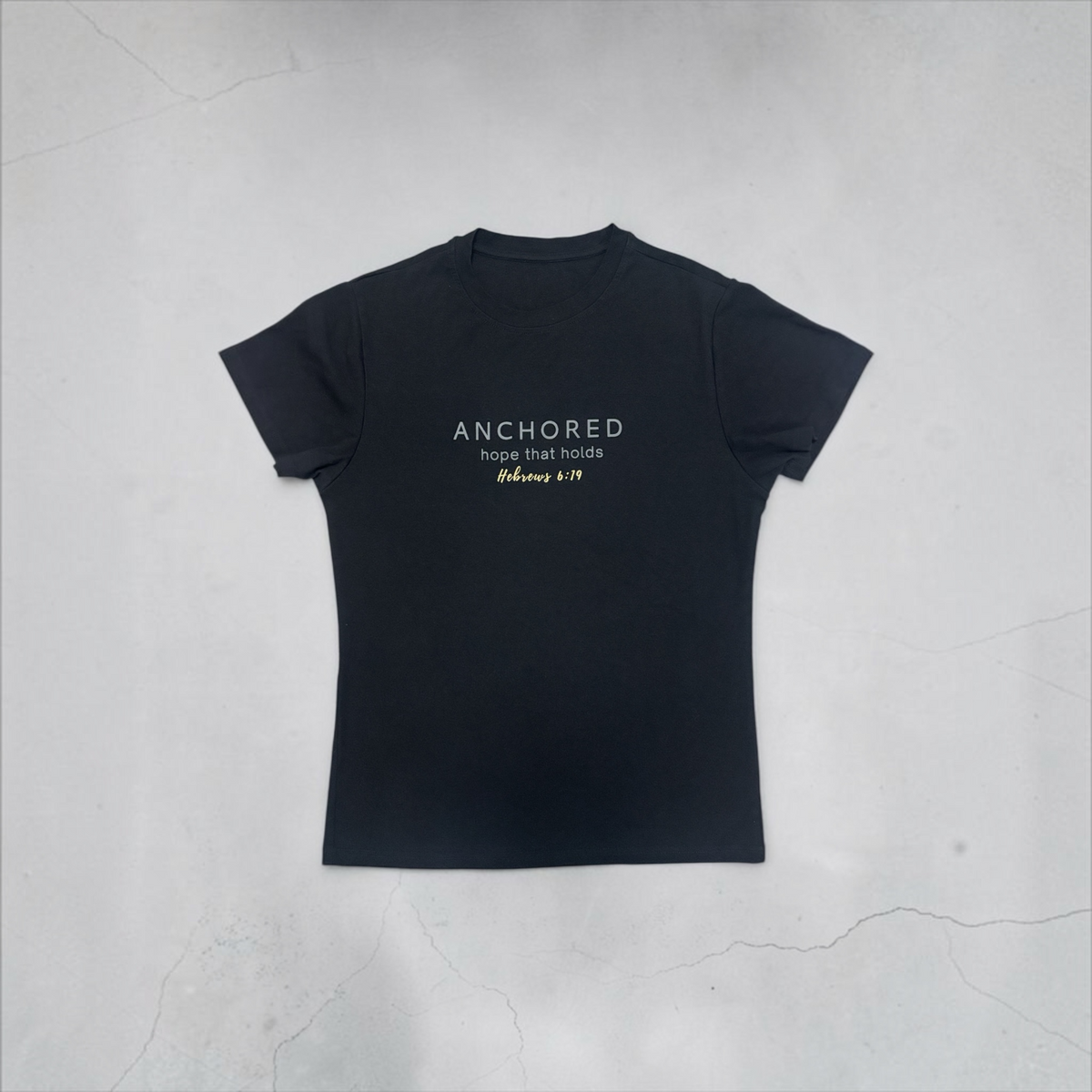 Black ADM Driven ANCHORED T-shirt laid flat, showing ‘hope that holds’ and Hebrews 6:19