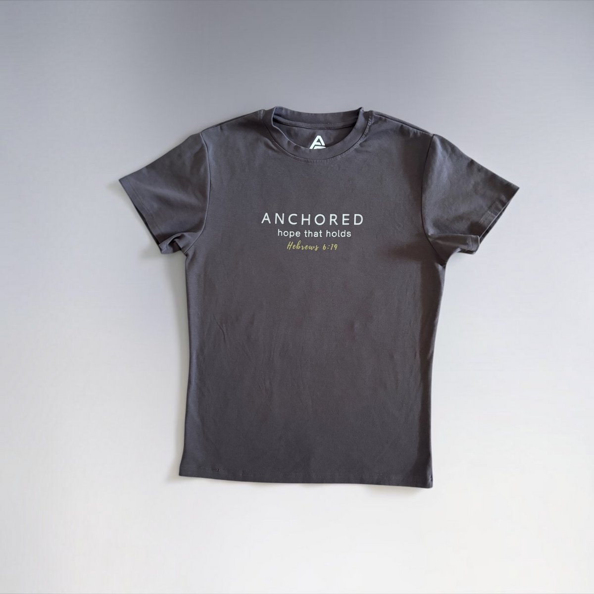 Charcoal Anchored men's shirt by ADM Driven displayed flat on a light background, featuring the message “Hope that holds,” inspired by Hebrews 6:19.