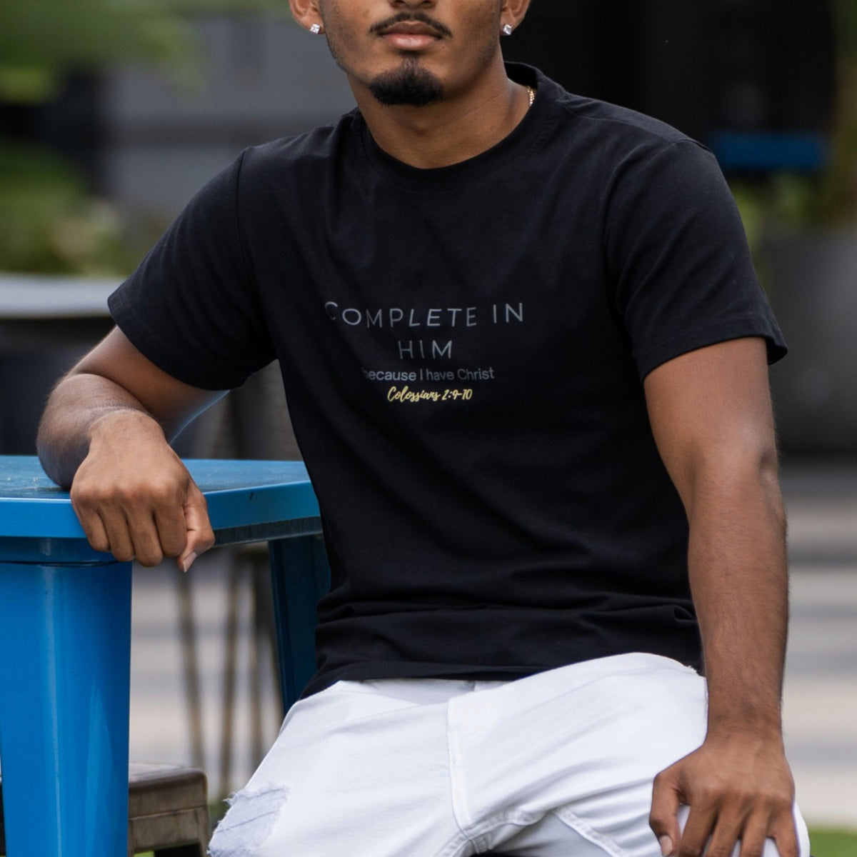 Man wearing the black Complete In Him shirt by ADM Driven, showcasing the chest design inspired by Colossians 2:10.